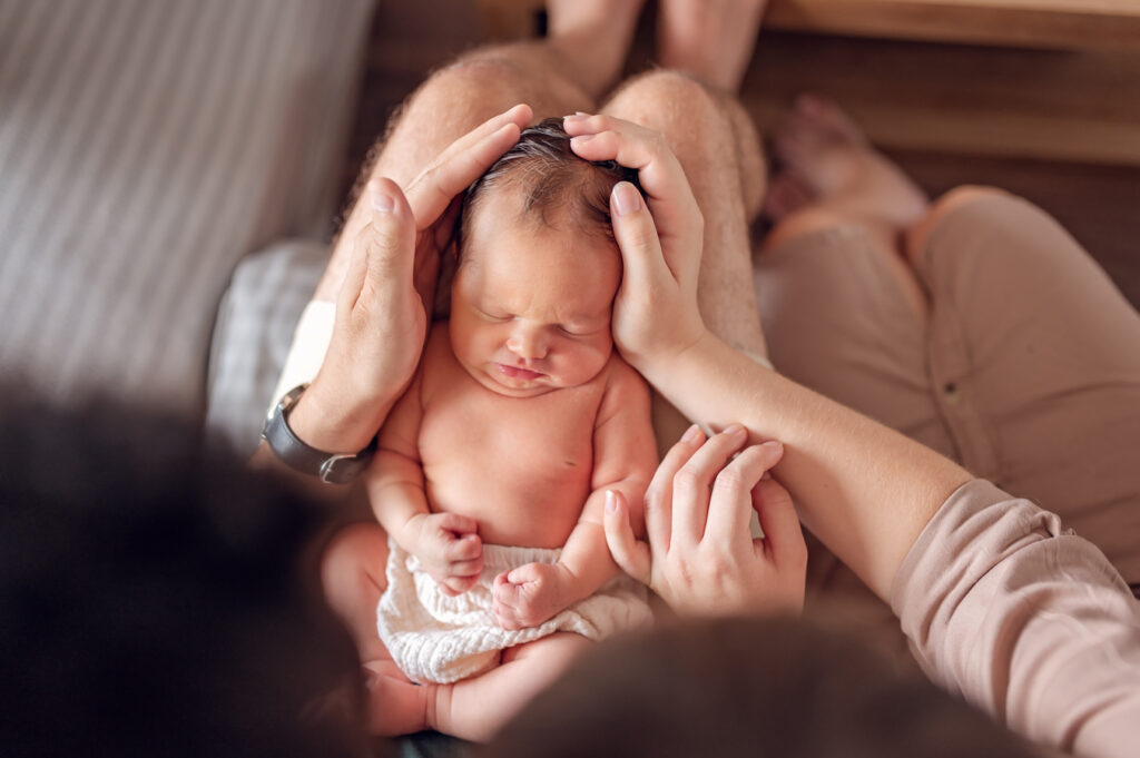 Sesja noworodkowa lifestyle Gdańsk noworodek śpi na kolanach taty