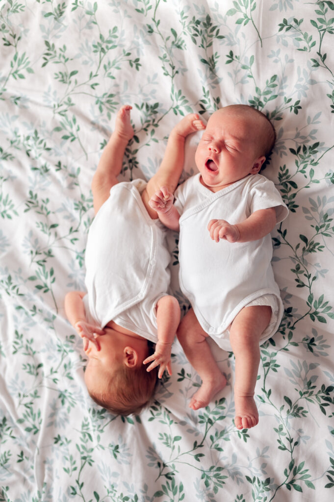 Zdjęcie z sesji noworodkowej w Gdyni przedstawiające uśmiechnięte bliźniaki