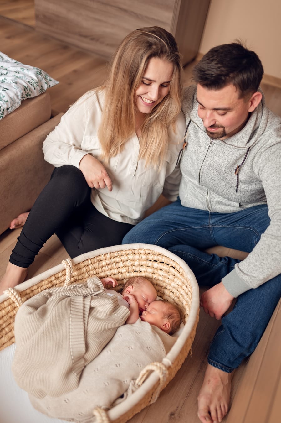 Rodzice patrzą na bliźnięta w koszu sesja Gdynia