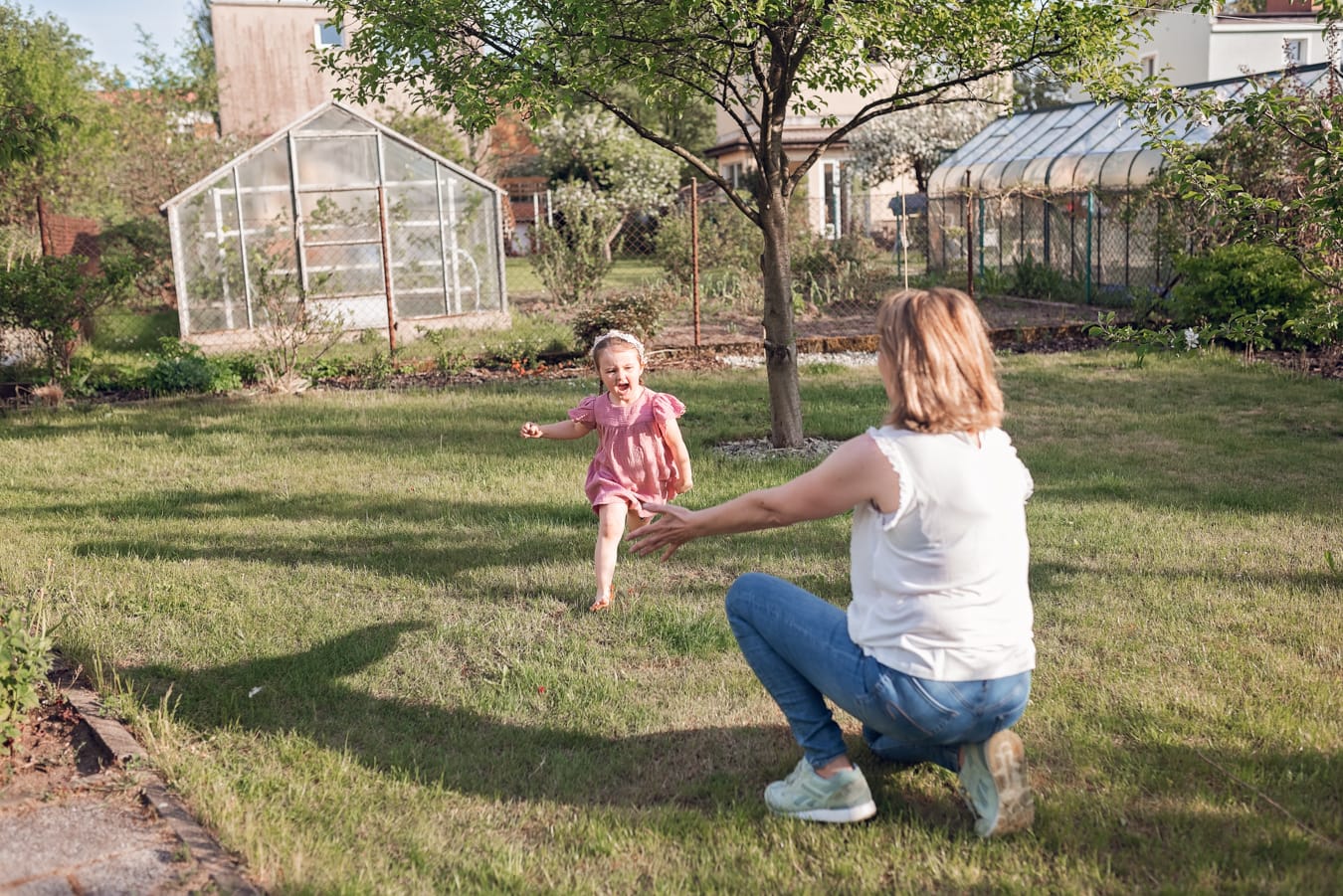 Ujęcie pełne uśmiechów i spontaniczności - wielopokoleniowa sesja rodzinna w ogrodzie dziadków