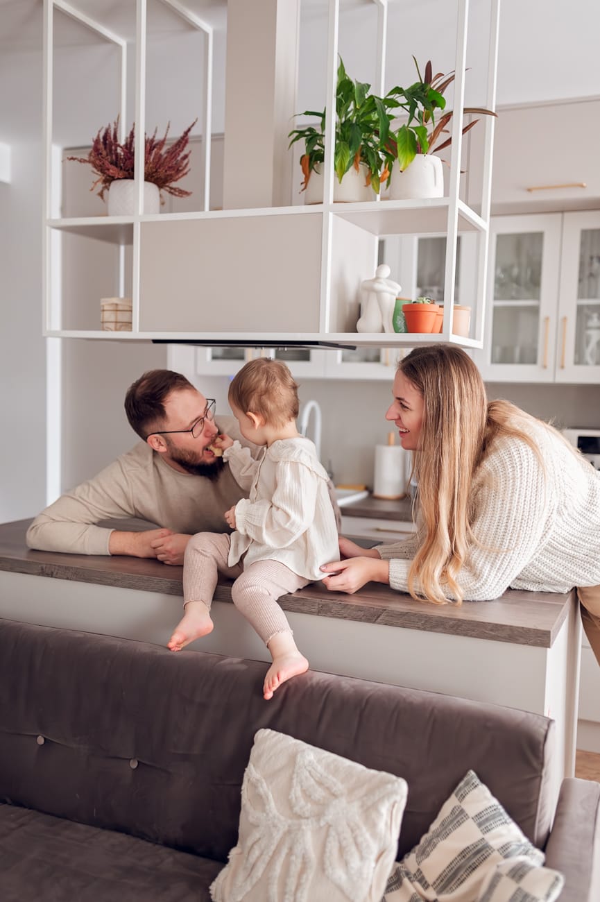 Córka karmi tatę w kuchni sesja rodzinna w domu