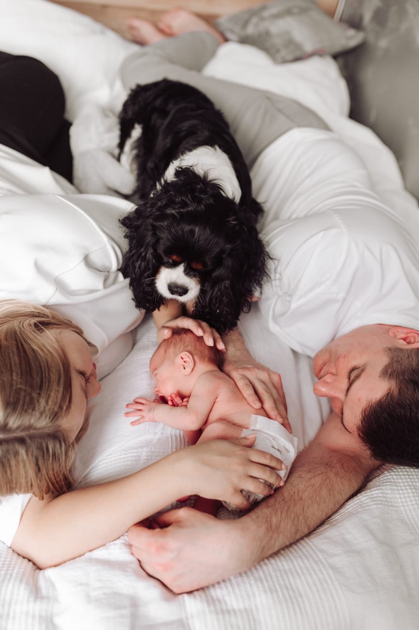 Rodzice z noworodkiem na łóżku sesja lifestyle Gdynia