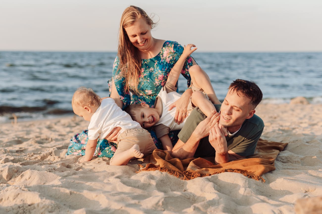 Rodzina na plaży zabawy sesja o zachodzie słońca