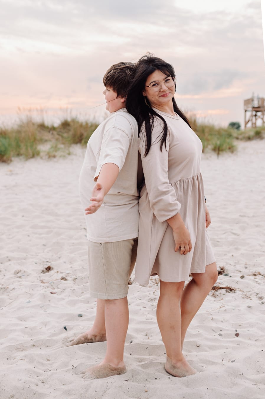 Mama i nastoletni syn mierzą wzrost sesja na plaży